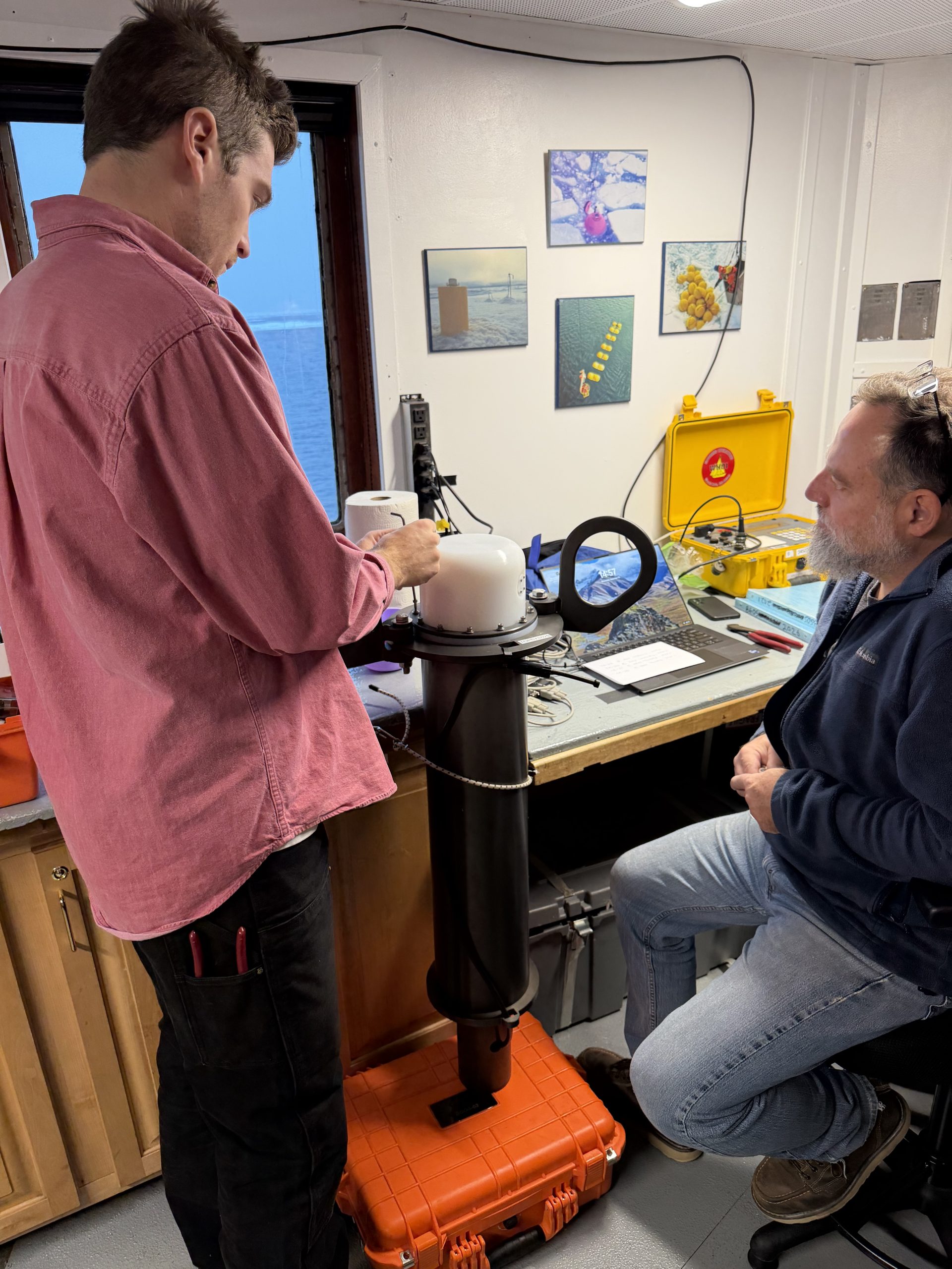 Tim McDonough (left) and Jeff O’Brien (right) testing a new sea level pressure sensor that will be deployed on a tethered ocean profiler (TOP). Photo by Chris Basque. 
