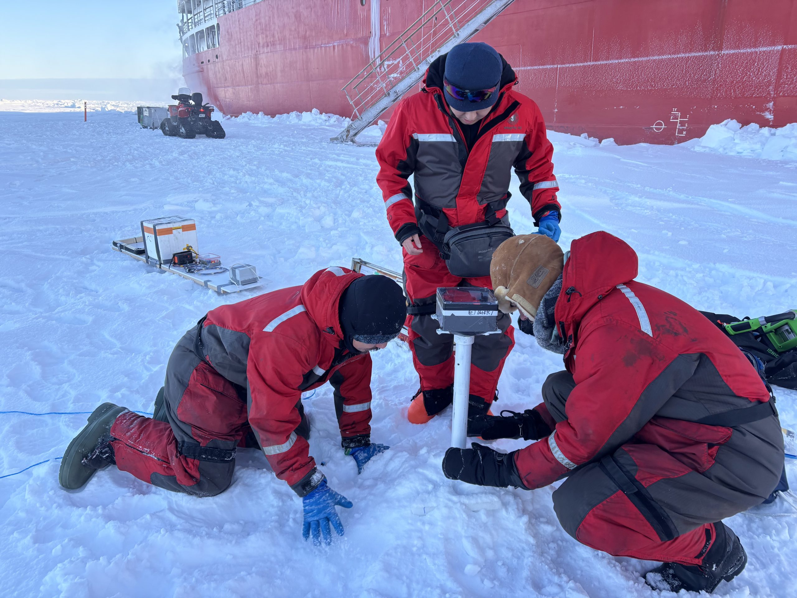(left to right) Takuji Waseda, Koya Sato, and Clement Feriot installing the wave sensor array. Photo by Jennifer Kosty. 