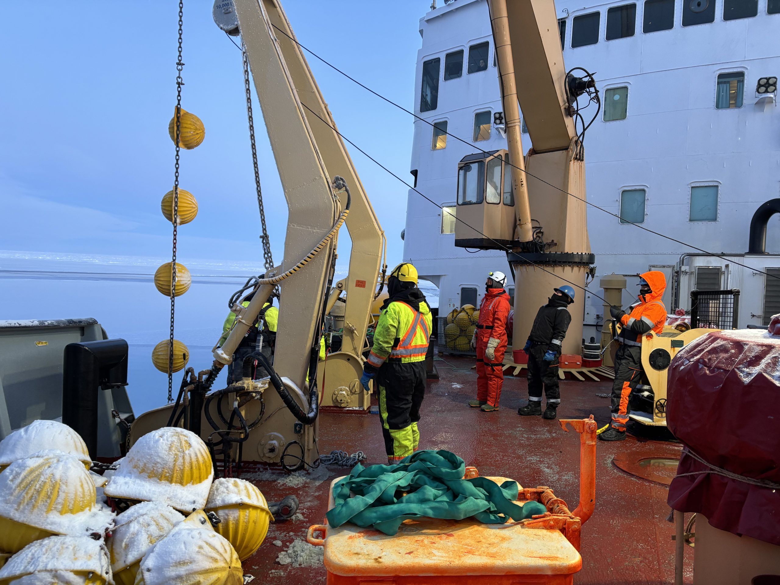 A set of glass buoyancy balls being added between reels of mooring wire. Photo by Jennifer Kosty. 