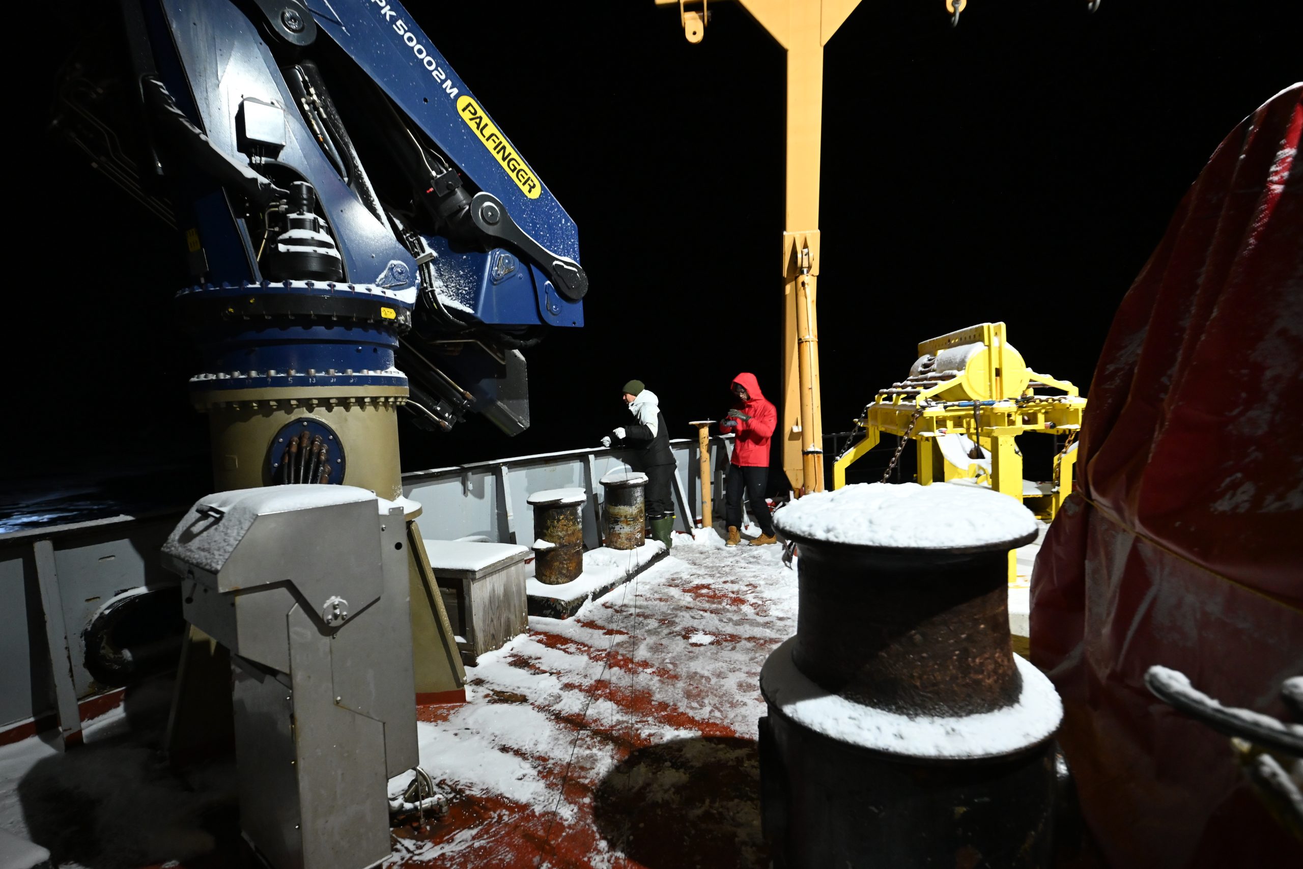 Takuji Waseda (left) and Hayate Kato (right) deploying a wave sensor in the MIZ. Photo by Kazu Tateyama. 