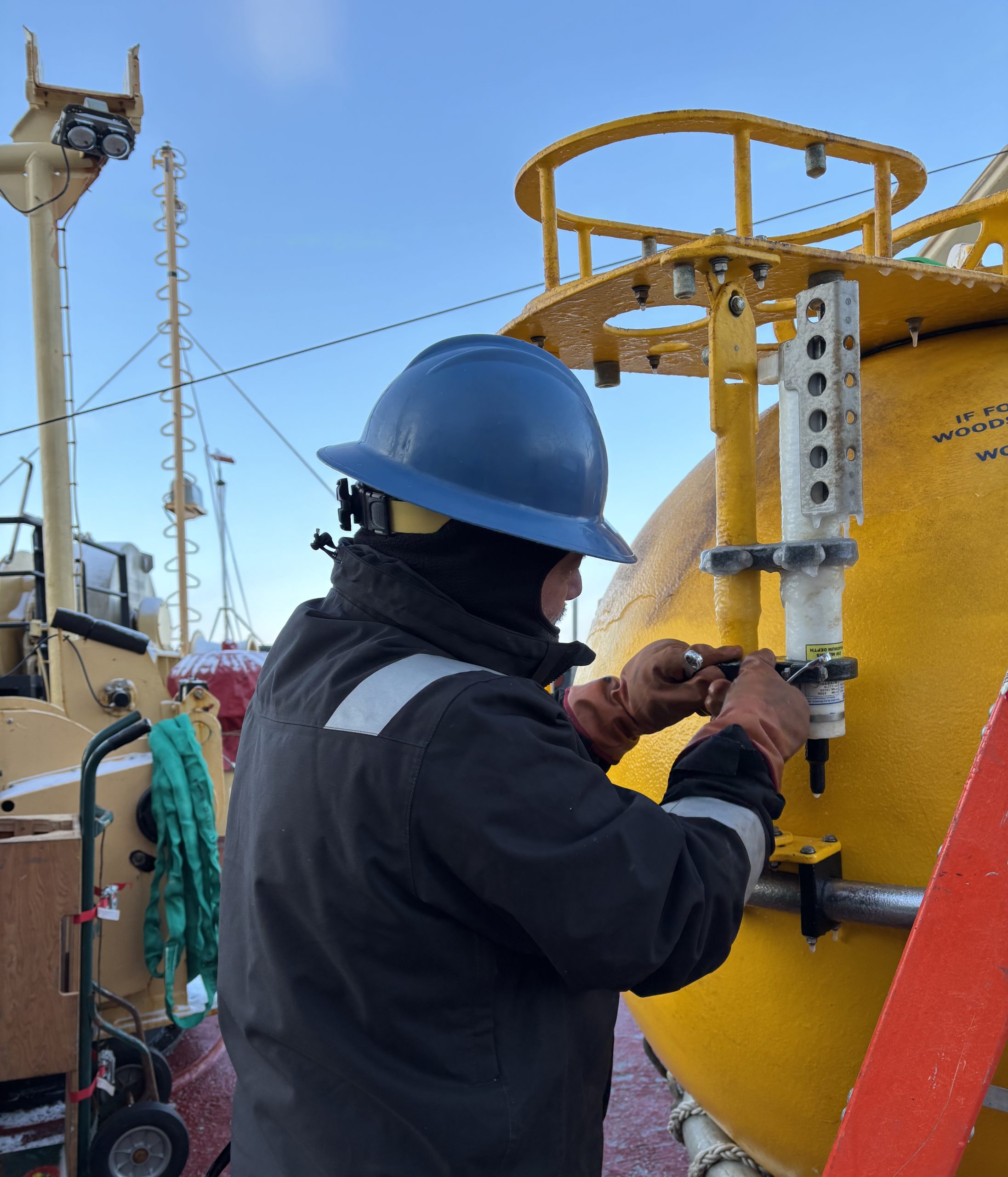 Jeff O’Brien removing a frozen Microcat instrument from Mooring B’s top sphere. Photo by Jennifer Kosty. 