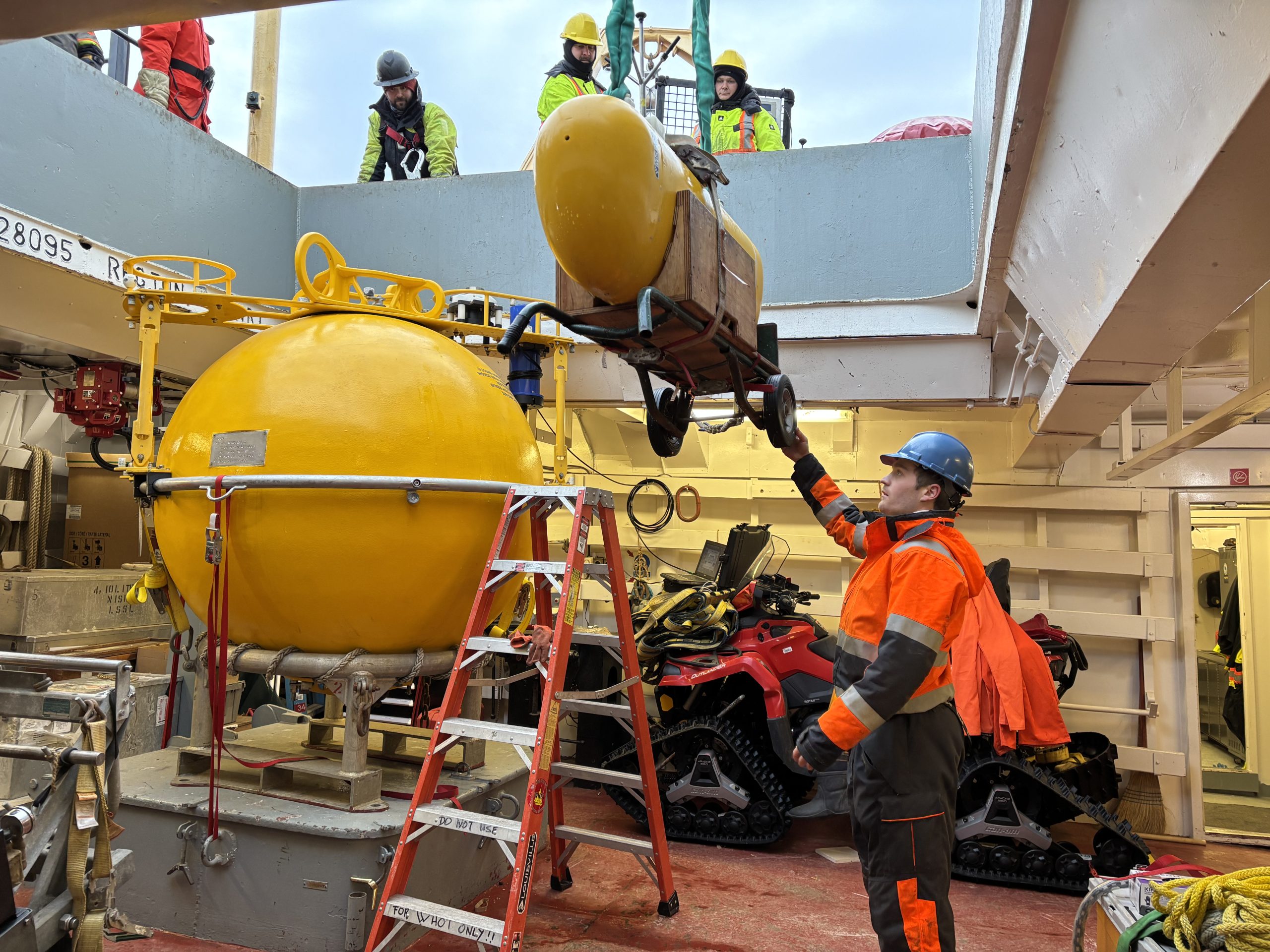 Tim McDonough guiding one of Mooring A’s McClane Moored Profilers (MMPs) as it is lowered into the forward hold. Photo by Jennifer Kosty. 