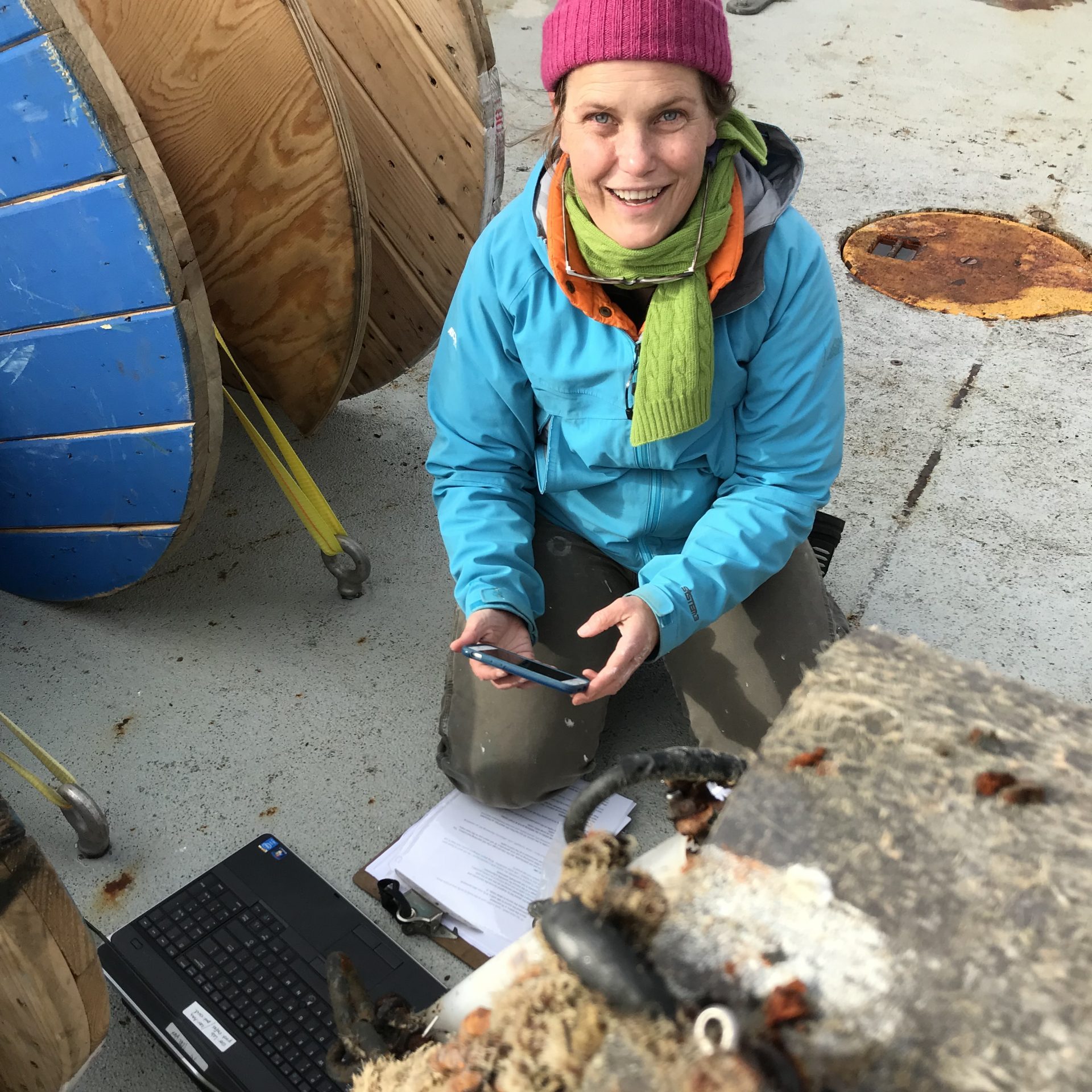 Heather Furey working on the back deck of the R/V/ Armstrong research ship, getting a instrument ready for sea.