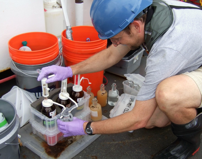 WHOI chemist Ben Van Mooy adds chemical reagents to water samples