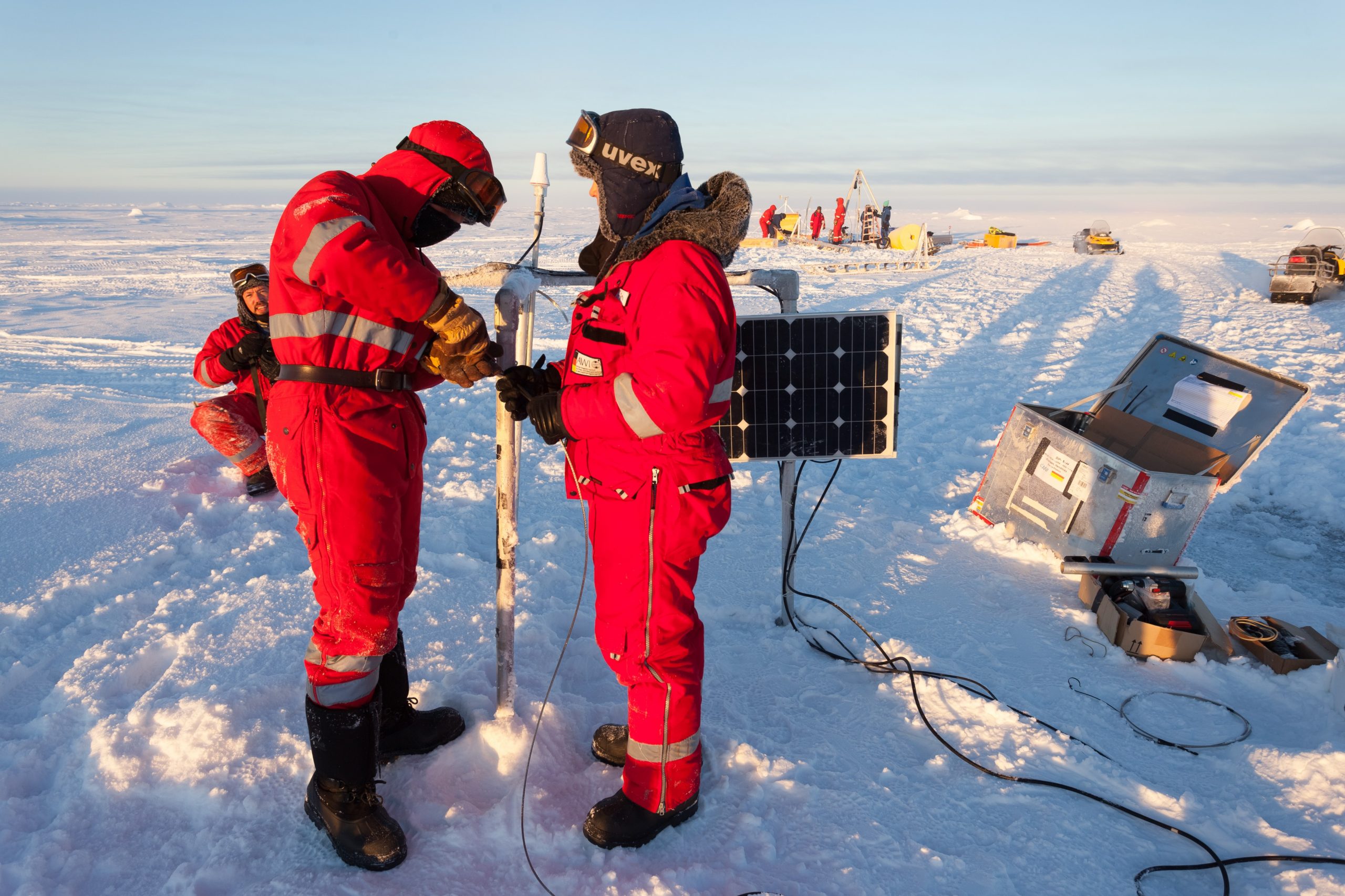 S. Hendricks, R. Ricker and J. Beckers assembling a spectral radiation station (with the ITP deployment in the background). (Photo by Mario Hoppmann)