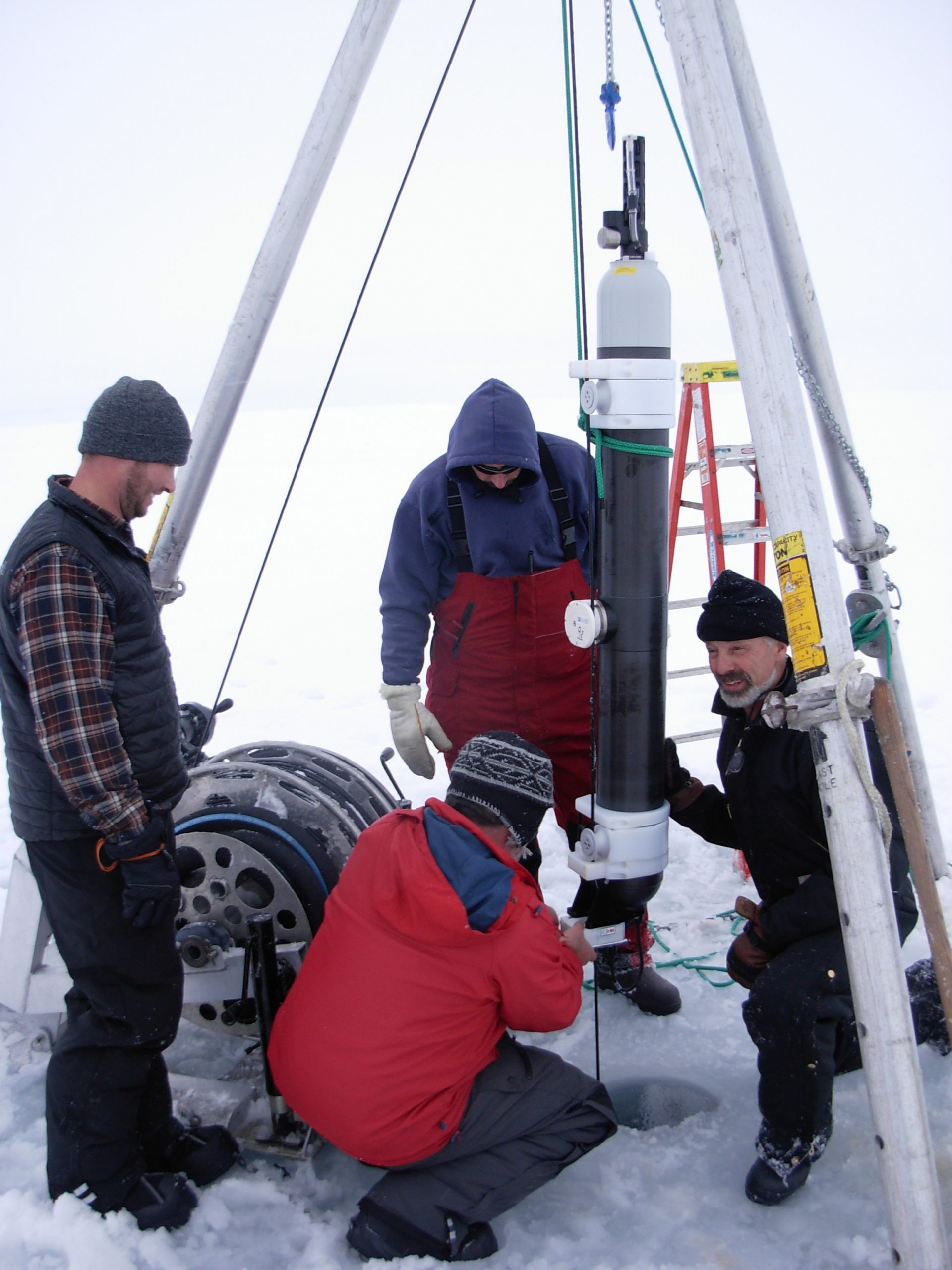 ITP profiler modem coupling being assembled around the wire by Jeff O’Brien while Chris Basque, Cory Beatty and Will Ostrom look on.  (Photo by Rick Krishfield)