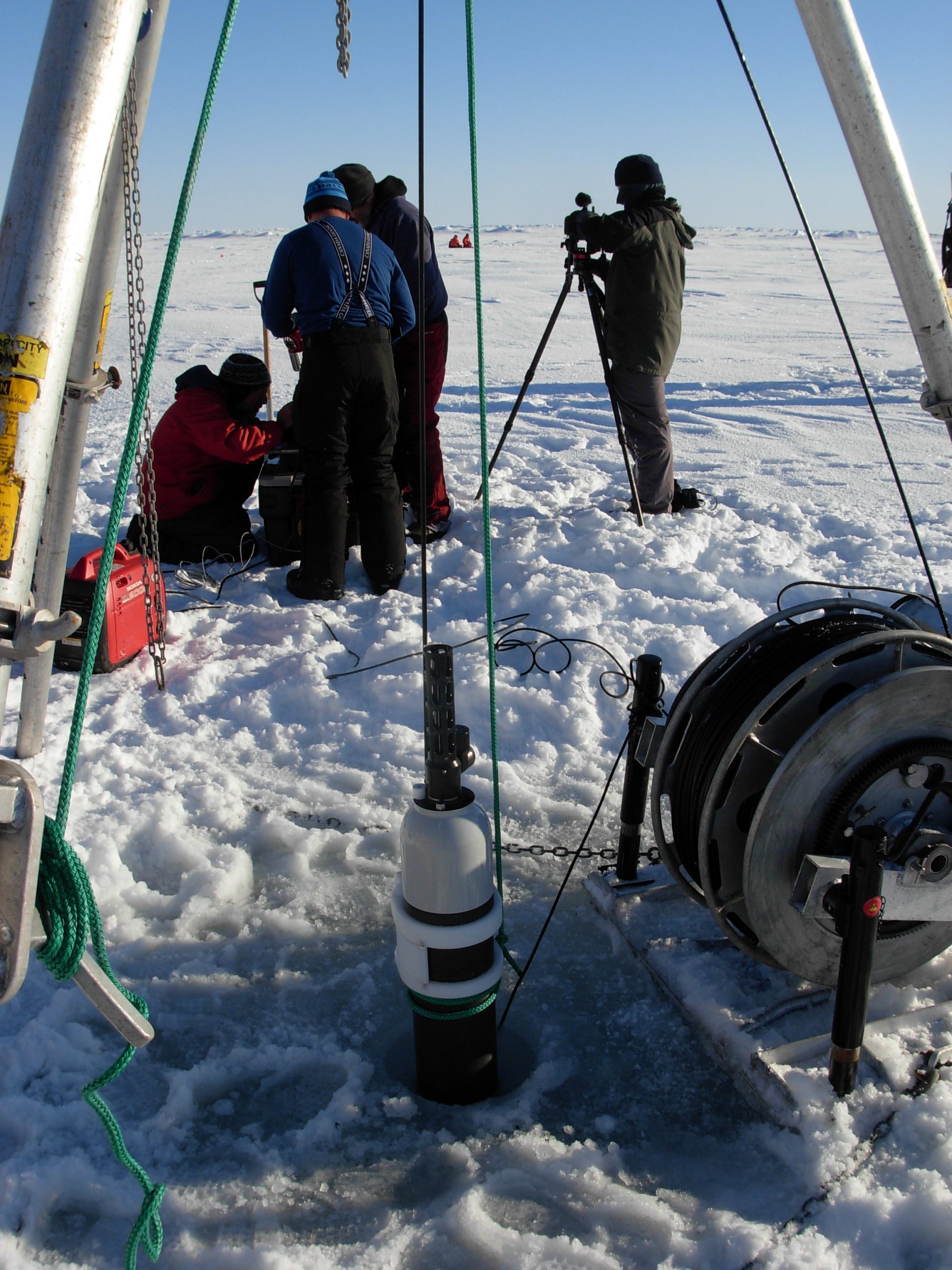 ITP 107 profiler is suspended in the seawater through the ice hole while the inductive modem test is performed. (Photo by Rick Krishfield)