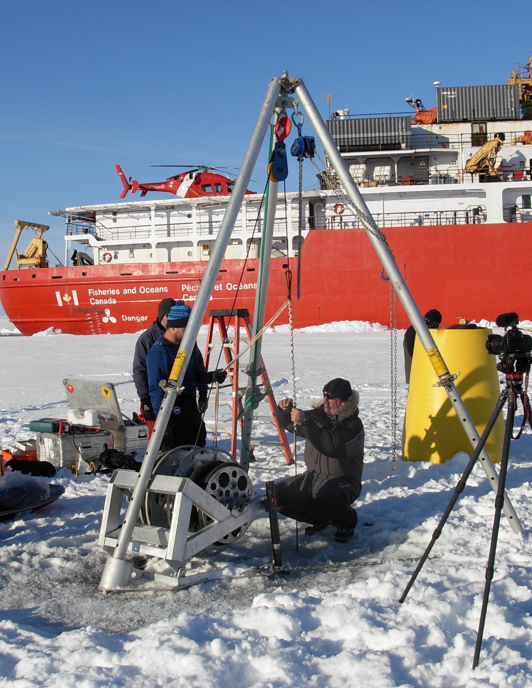 A Yale grip is applied to the ITP tether by Jim Ryder to take the load before attaching the surface package. (Photo by Rick Krishfield)