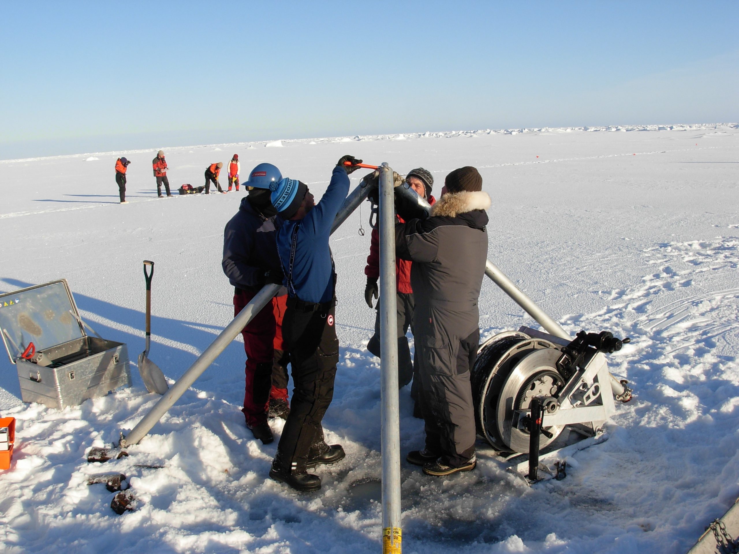 Assembling the ITP deployment tripod over the ice hole. (Photo by Rick Krishfield)