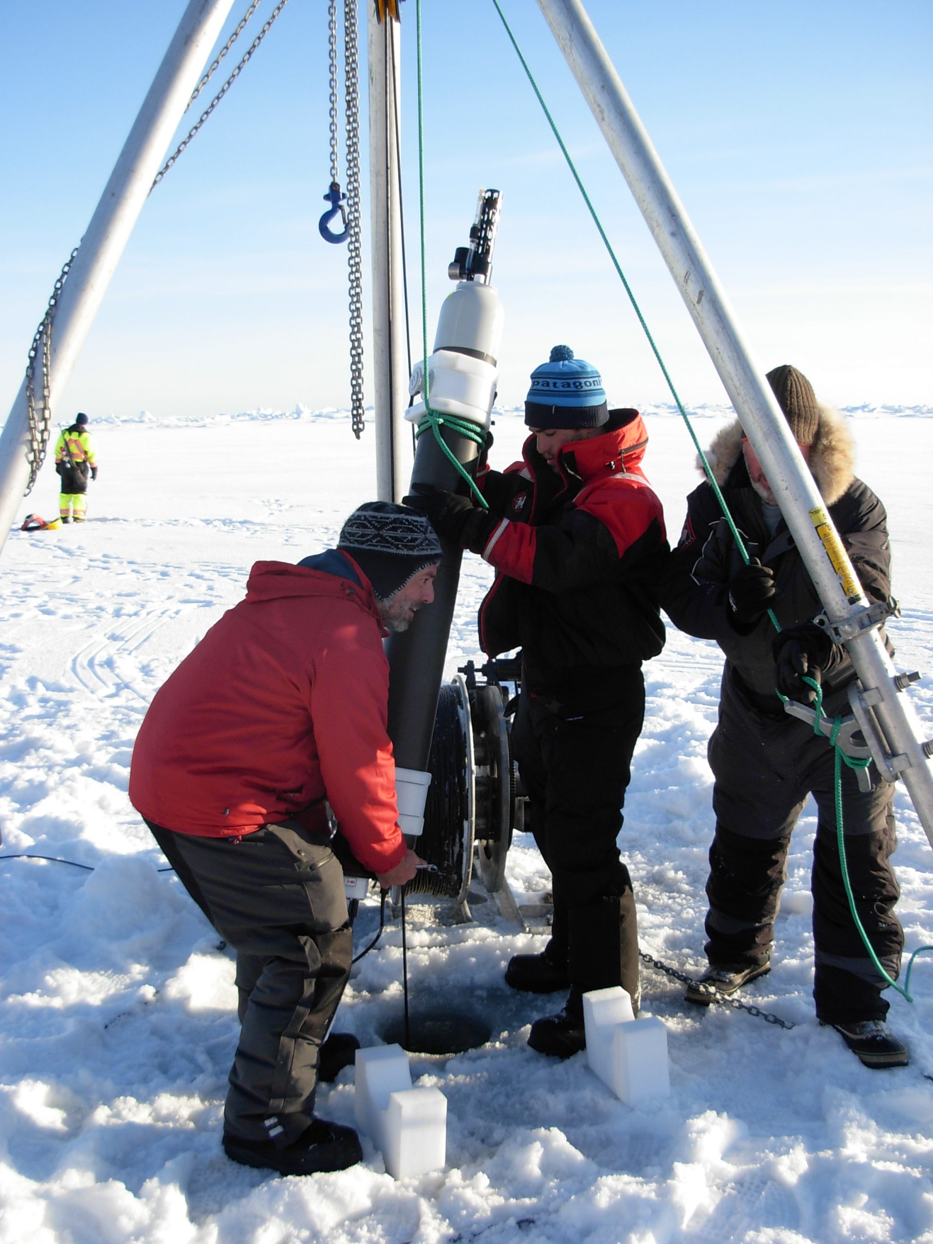 O’Brien and Nico Llanos hoist ITP profiler into place next to the tether wire. (Photo by Rick Krishfield)