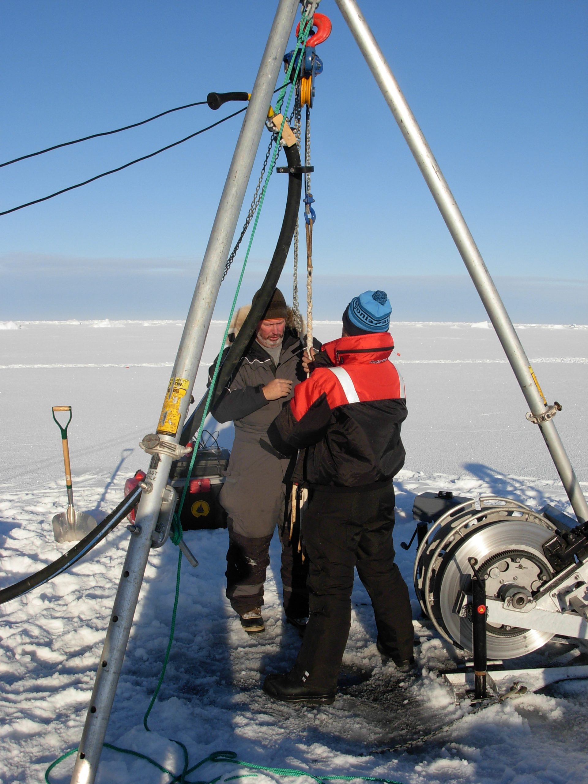 Jim Ryder and Llanos slip the Yale grip in preparation for installation of the surface package. (Photo by Rick Krishfield)