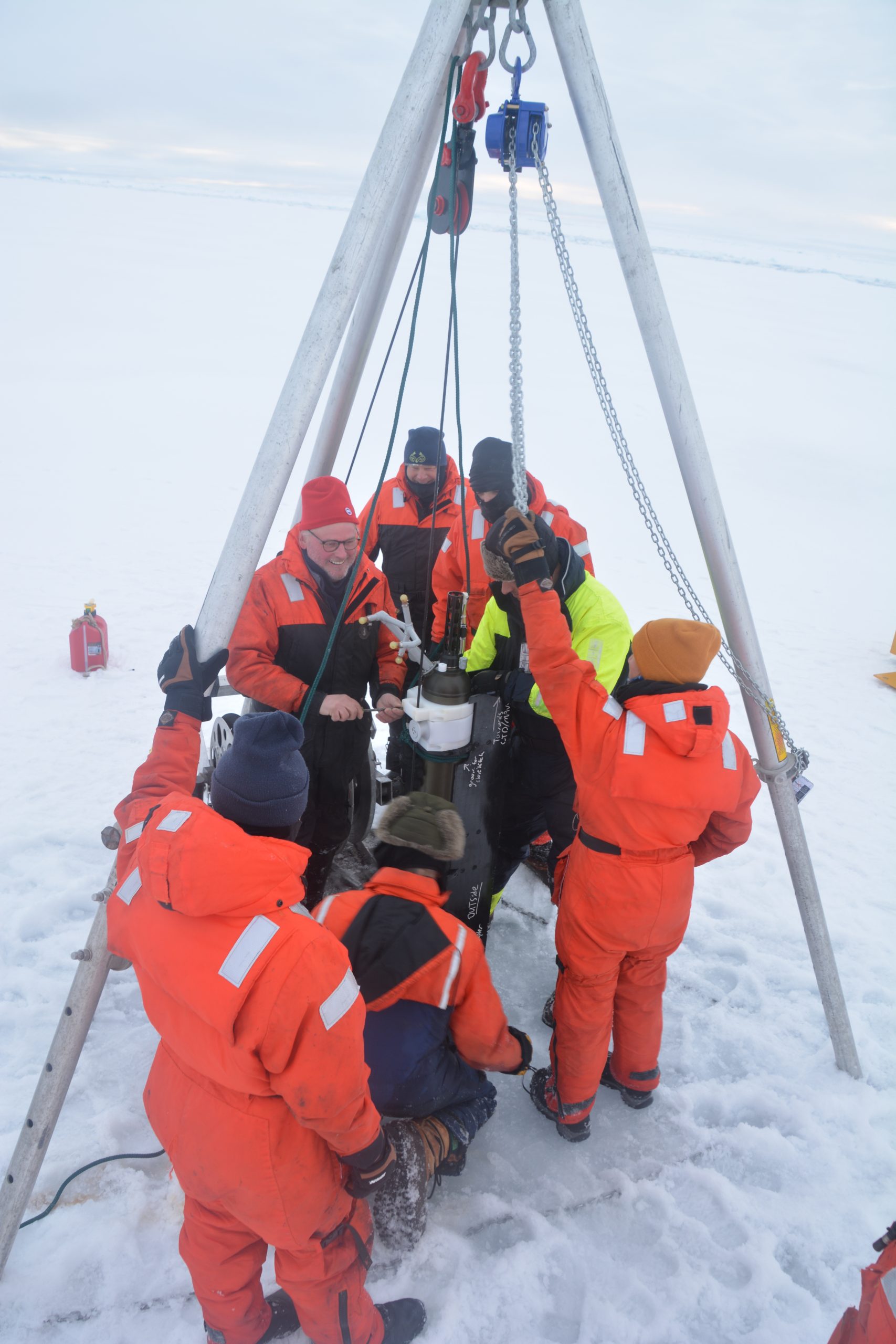 John Kemp attaches clamp to profiler on the wire. (Photo by ENS Layman)