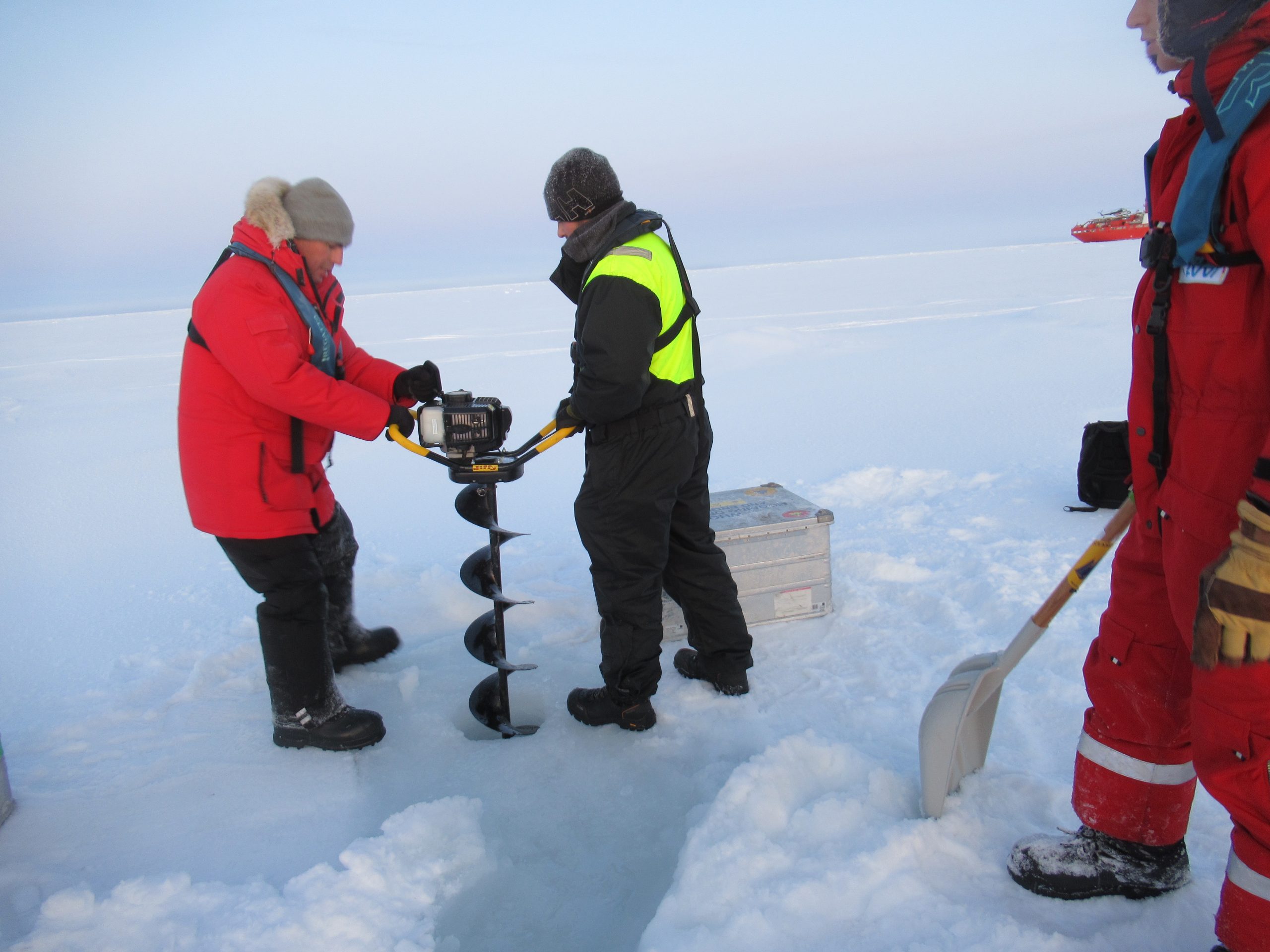 Andrew Davies and Chris Basque augering the 12” hole through 2.8 meter of ice using a Jiffy two-stroke drill. (Photo by Andy Davies)