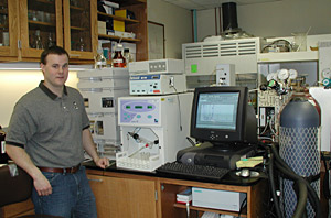 Sean Sylva prepares to use the High Peformance Liquid Chromatograph
